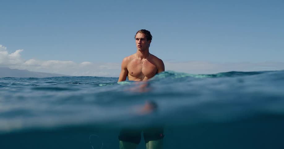 Man standing on a surfboard in the ocean
