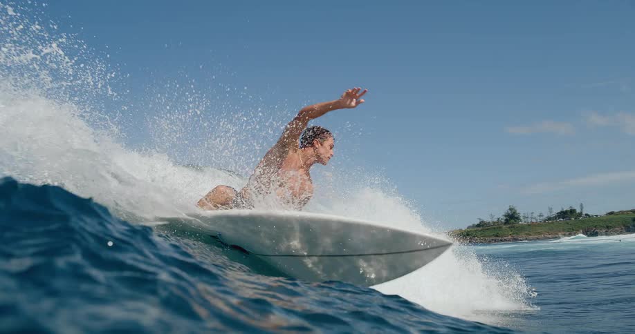 Man surfing a wave on the beach