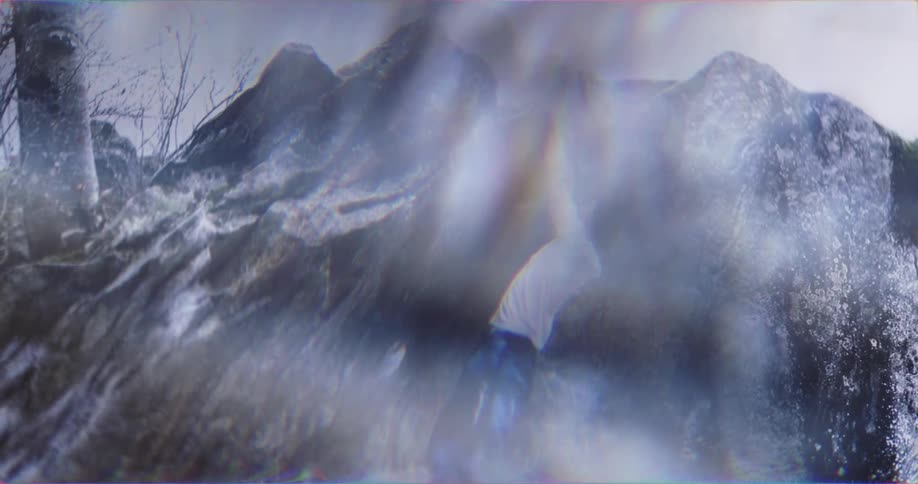 Person climbing a steep rock with hands gripping the edge