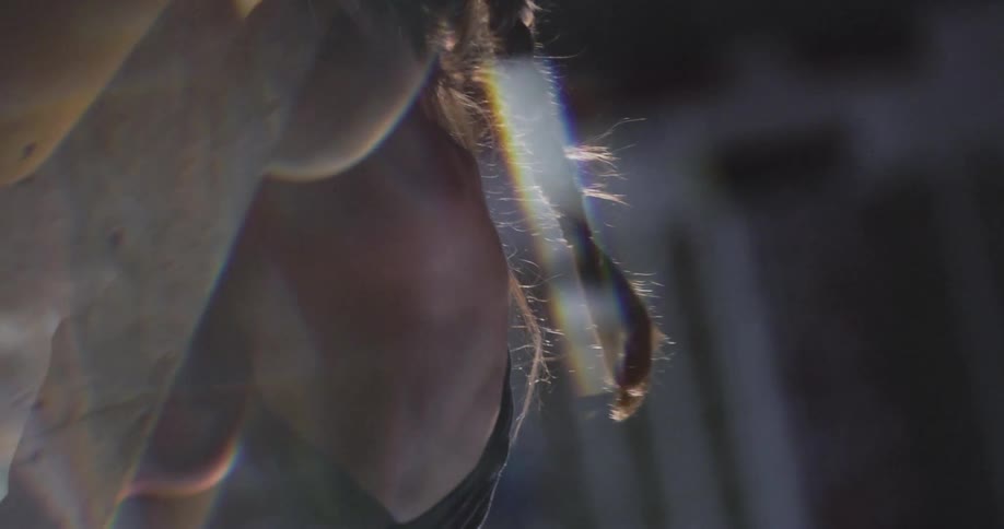 Woman with braids practicing rock climbing indoors