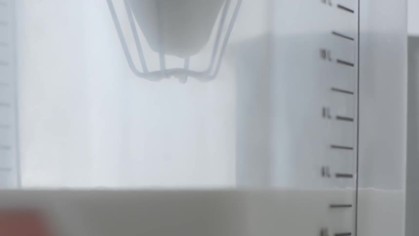 Milk drips down into a large container