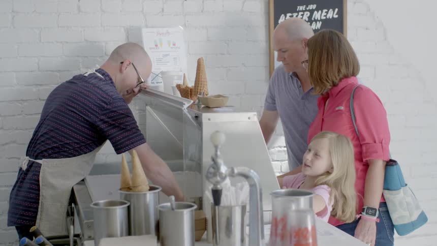 A family is ordering ice cream in a parlor