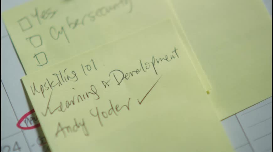 Close up of small yellow sticky notes with handwritten texts placed on a book
