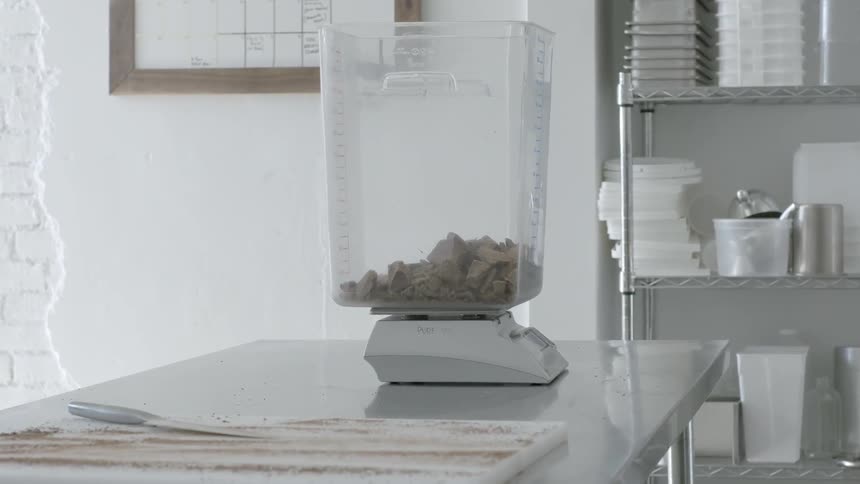 A container sits on a machine in this kitchen