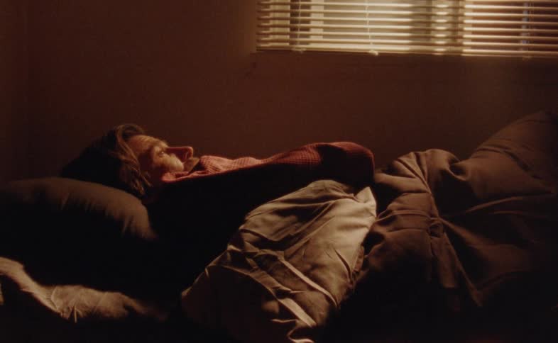 Close up of a man lying in bed contemplatively