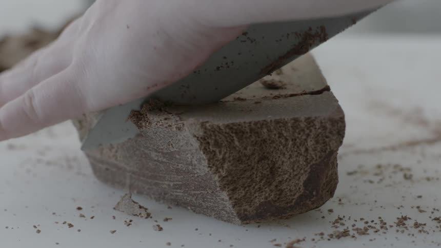 A person chops chocolate with a knife