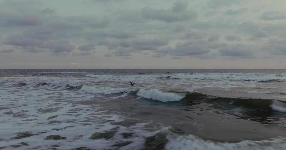 Rough sea waves under a cloudy sky