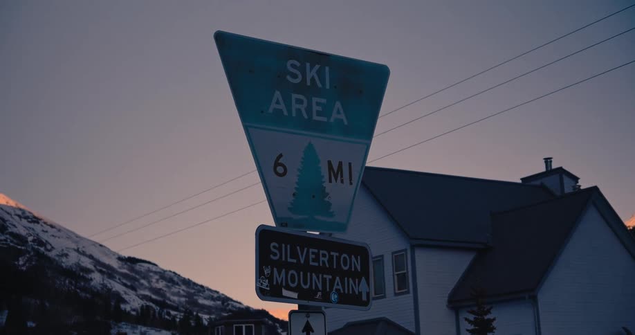 A sign for a ski area outside a home