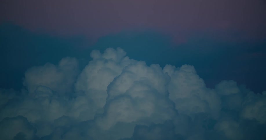 Dense clouds lit by the sunset in shades of blue and pink