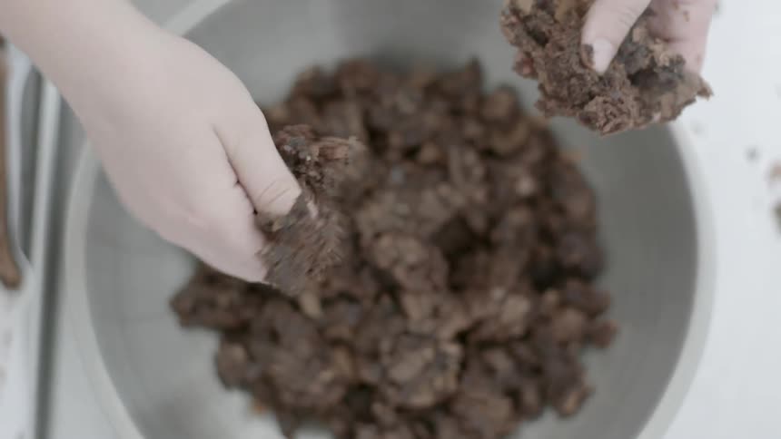 A person is crushing some food into a bowl