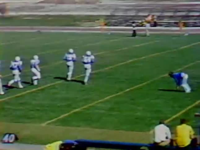 Football players charge down the field as someone does a flip