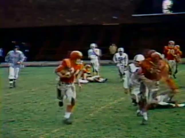 Two teams play football on a field