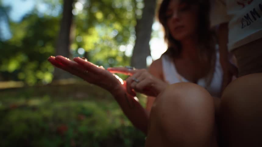 Mother with wet hand holding an object next to her little son