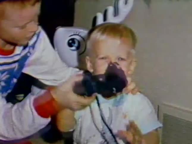 A boy looks through some binoculars