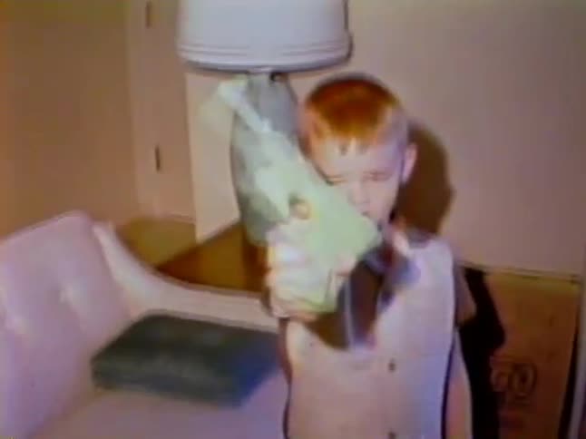 Little boy showing his water gun toy