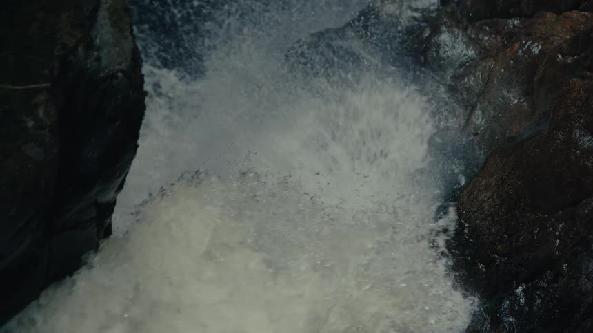 A waterfall between rocks outdoors during daytime