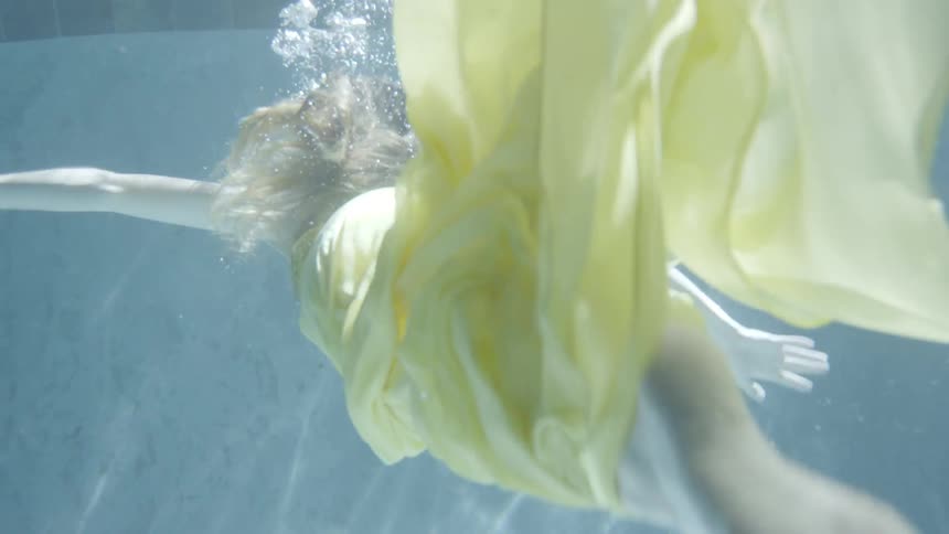 A woman swims in the water of a pool