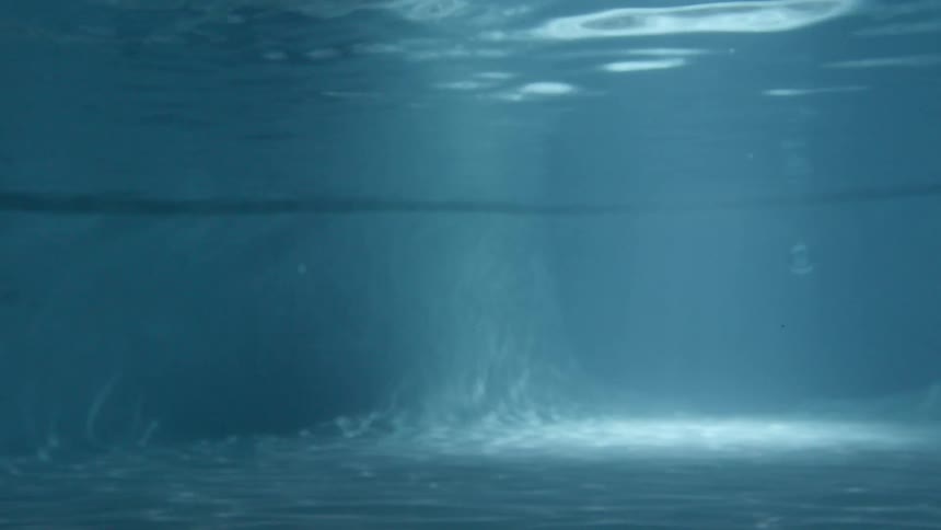 The light is shining in through the pool water