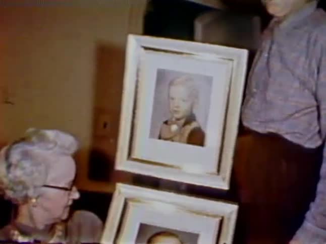 A woman looks over her portraits