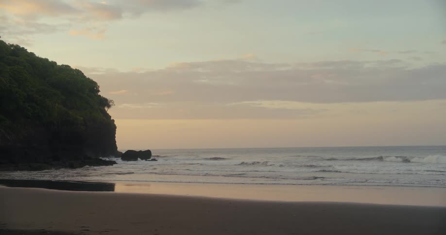 The sun is rising on the beach