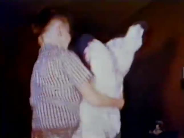 A boy is jumping around with his teddy bear