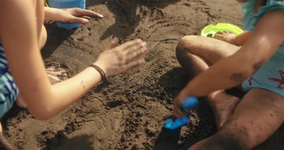 Barefoot children play in the sand on a summer day