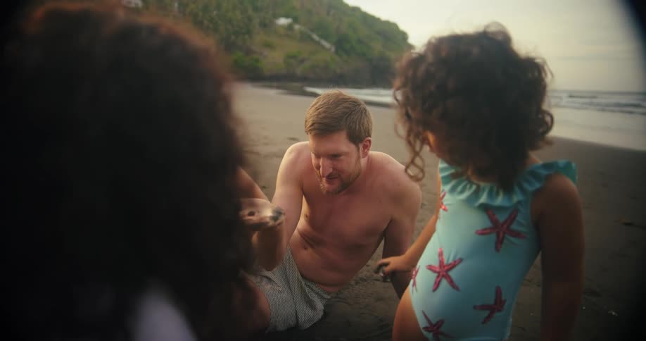 A family have fun in the sand