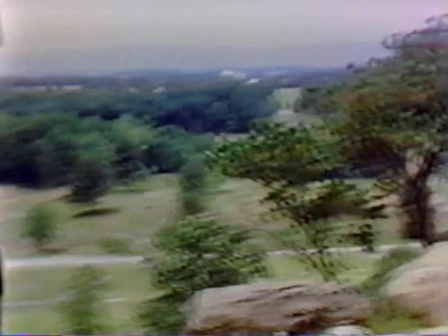 A man stands on a rock sightseeing
