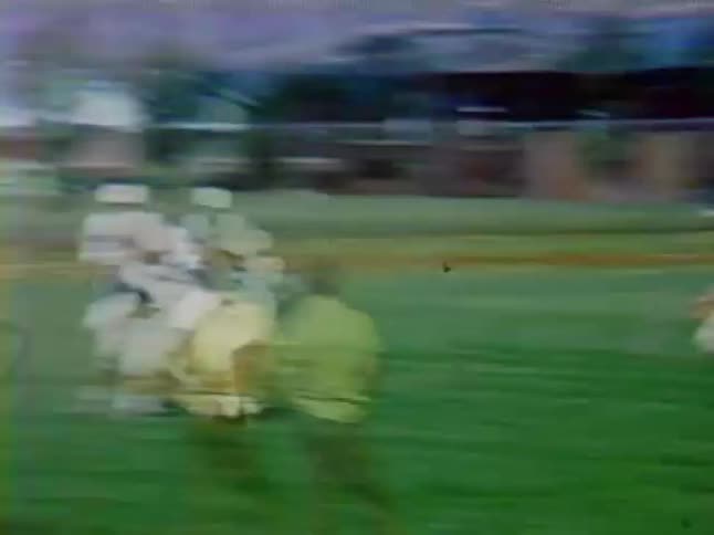 Football players throw the ball and charge down the field