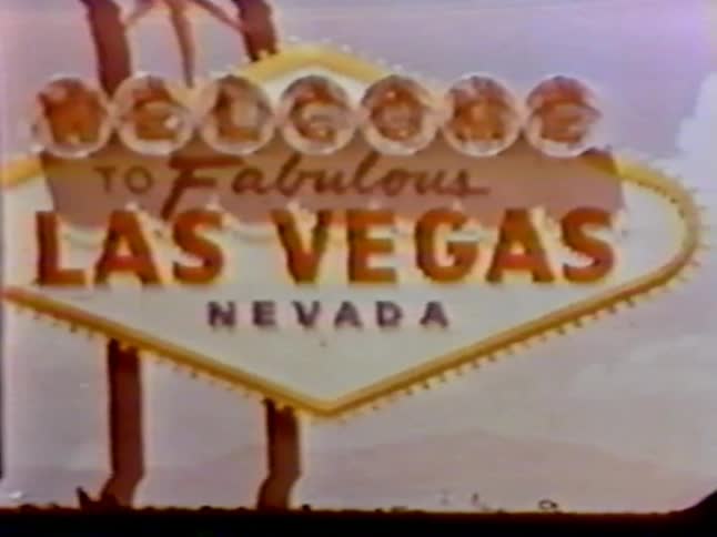 A las vegas sign hangs from a pole