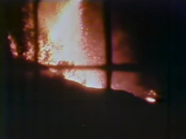 Lava flies behind the hills at night