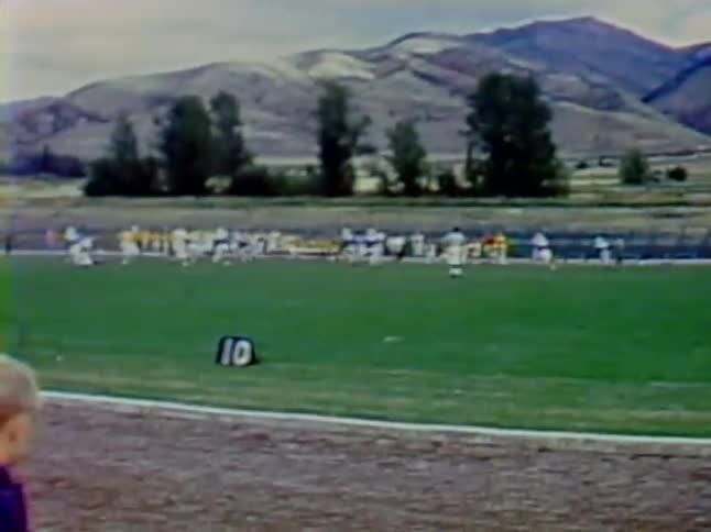 A football game is going on and everyone is running