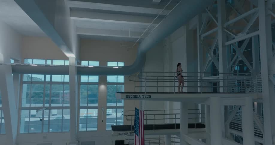 Athlete prepares for a dive on an olympic pool platform
