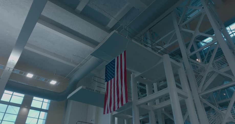 Diving platform at the georgia tech aquatic center with a united states flag hanging