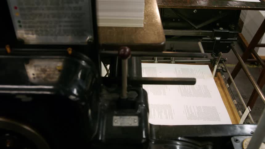 An automated printing press continuously outputs printed pages
