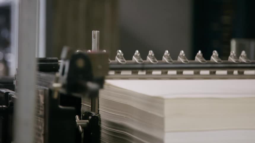 Stack of paper sheets positioned in an industrial printing machine