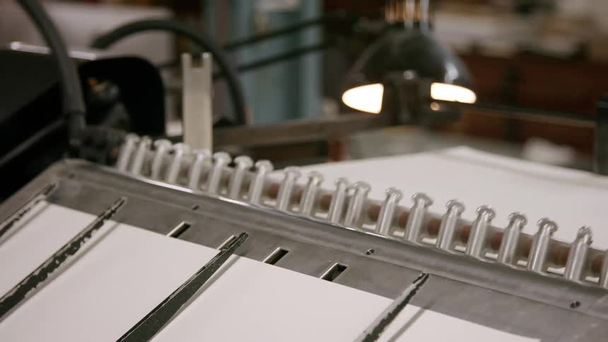 Sheets of paper move through a printing machine in operation
