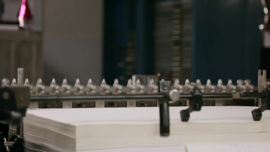 Stack of paper sheets aligned in an industrial printing machine