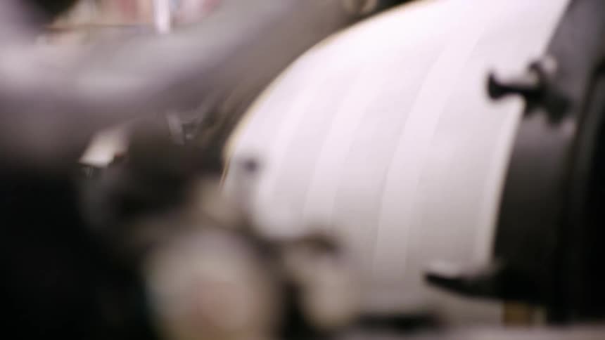 Printing roller in motion with sheets passing through the machine
