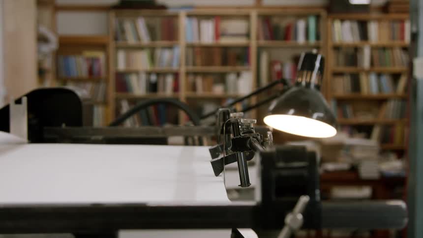 An automated printing press machine lifts pages of paper into itself