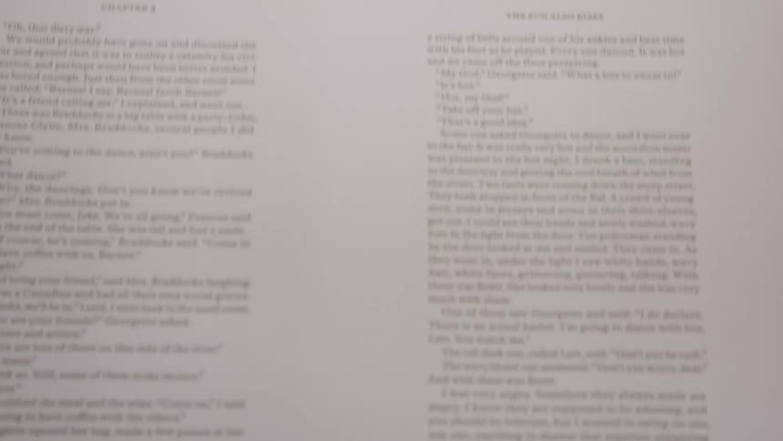 The video shows a printing machine in operation with paper moving rapidly across a surface the paper is covered in text and is folded in the middle as it passes through the machine018