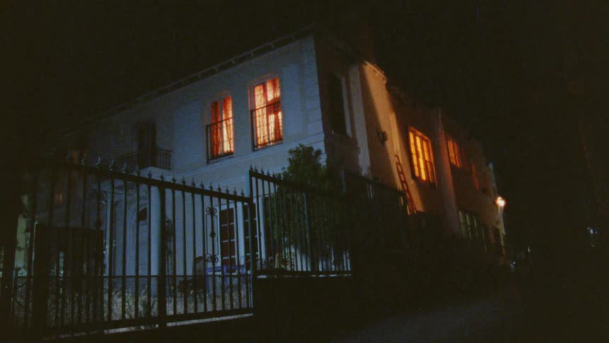 House lit from inside with orangeglowing windows at night