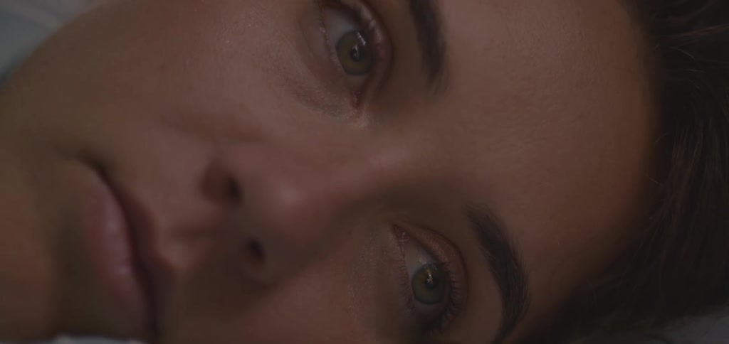 A close up portrait of a person opening and closing her eyes