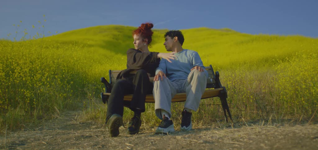 A couple people sitting on a bench