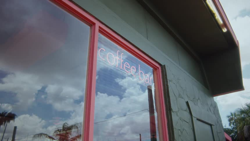 A sign for a coffee bar in a shop window