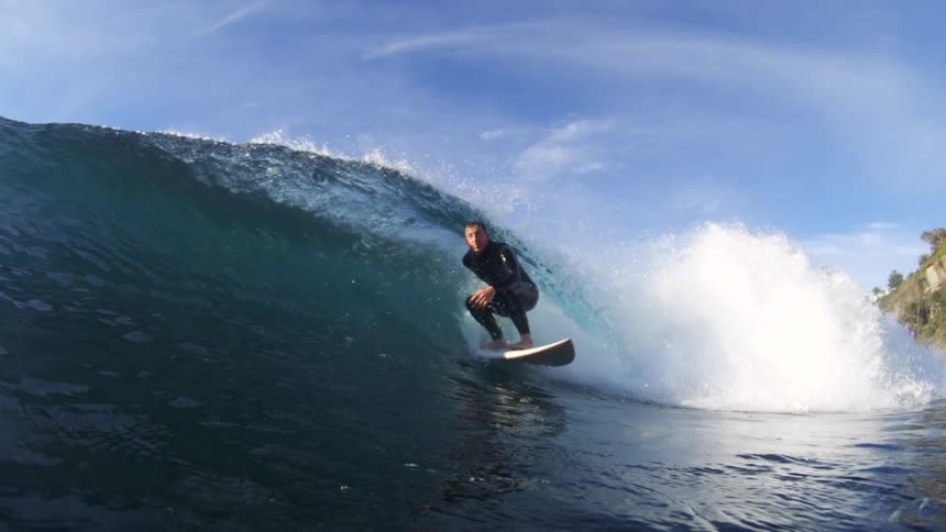 The surfer passes by on the large wave