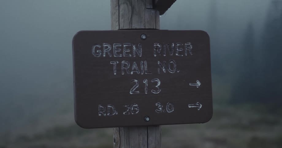 A sign on a wooden post