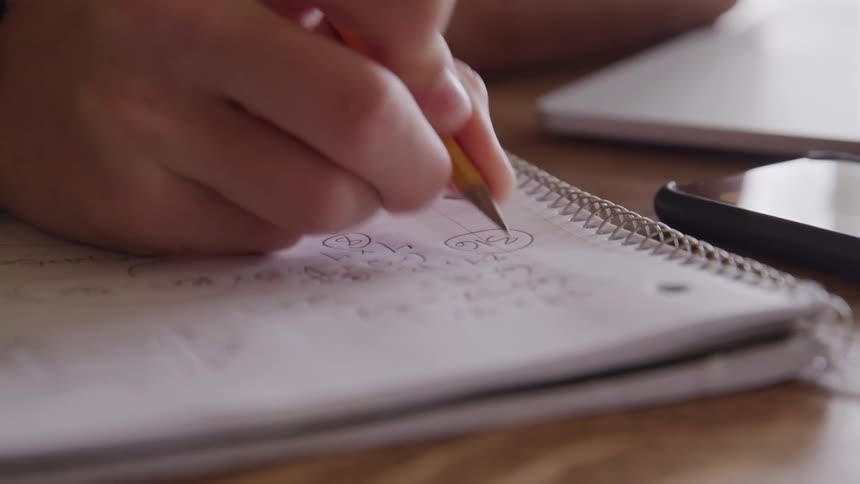 Hand writing in a spiral notebook