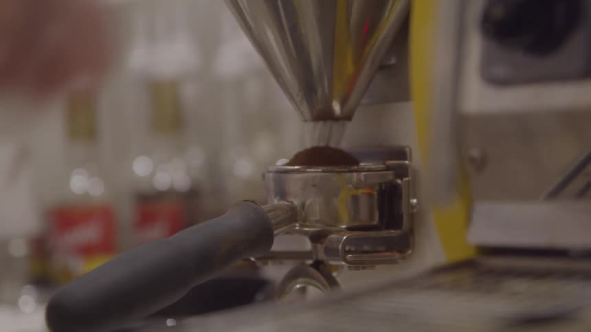 Hand locks portafilter into espresso machine