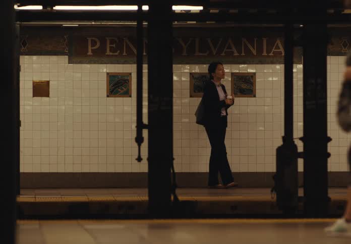 People pace on the subway platform while waiting for the train